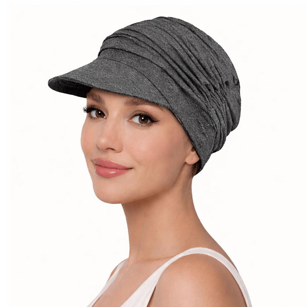 Chemo Cap - stretchy baseball style in grey worn by a woman, perfect for sunny days and stylish outfits.
